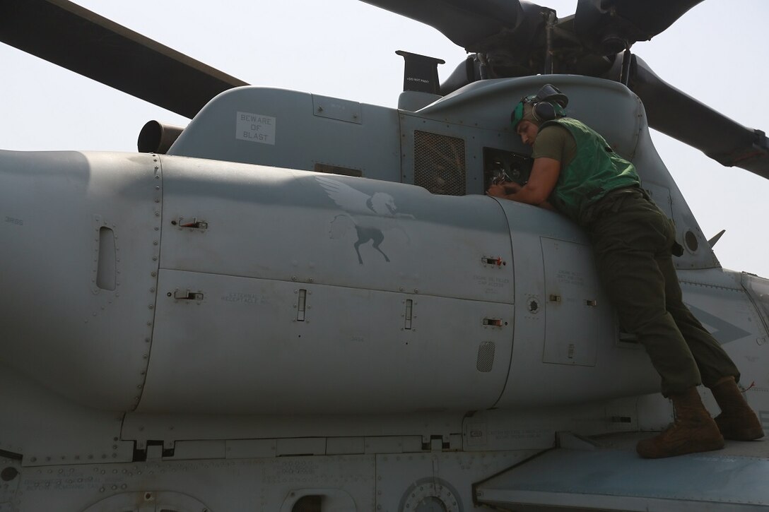 U.S. Marine Lance Cpl. Charlie Mendoza replaces a hydraulic line on an AH-1Z Viper from the “Greyhawks” of Marine Medium Tiltrotor Squadron 161 (Reinforced), 15th Marine Expeditionary Unit, on the flight deck of the amphibious transport dock ship USS Anchorage (LPD 23). Mendoza is an airframes mechanic with VMM-161 (Rein.), 15th MEU. The “Greyhawks” are the aviation combat element of the 15th MEU, and embarked aboard the ships of the Essex Amphibious Ready Group, are deployed in support of maritime security operations and theater security cooperation efforts in the U.S. 5th Fleet area of operations. (U.S. Marine Corps photo by Sgt. Steve H. Lopez/Released)