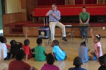 Daniel Tait, left, of the Alabama Center for Sustainable Energy, and Wesley Malone, of the Engineering and Support Center, Huntsville, talk with students about renewable energy during July 10 event.