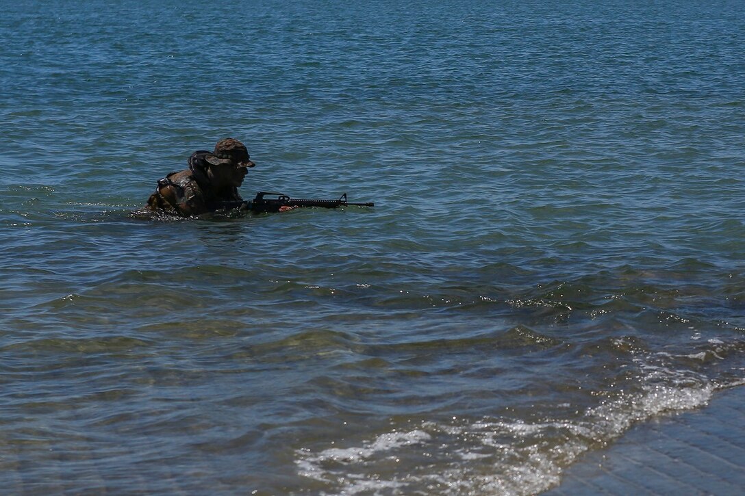 A reconnaissance Marine with 1st Reconnaissance Battalion, 1st Marine Division, demonstrates amphibious capabilities to Devil Pups aboard Marine Corps Base Camp Pendleton, Calif., July 12, 2015. After the demonstration, the Marines held a question and answer session for the students who wanted to know more about the reconnaissance community. (U.S. Marine Corps photo by Cpl. Will Perkins)