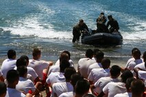 Reconnaissance Marines with 1st Reconnaissance Battalion, 1st Marine Division, demonstrate amphibious capabilities to Devil Pups aboard Marine Corps Base Camp Pendleton, Calif., July 12, 2015. After the demonstration, the Marines held a question and answer session for the students who wanted to know more about the reconnaissance community. (U.S. Marine Corps photo by Cpl. Will Perkins)