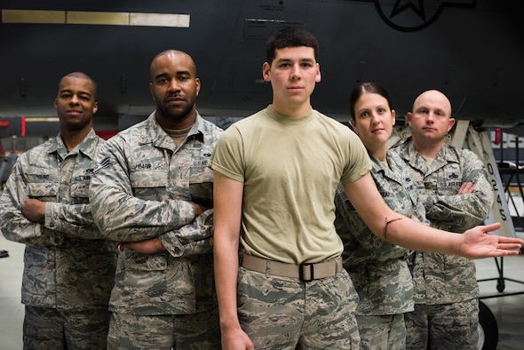 Airmen from the 366th Equipment Maintenance Squadron at Mountain Home Air Force Base, Idaho, stand behind Airman 1st Class Saul Vasquez (center) May 14, 2015. On April 2, 2015, Vasquez tore his radial artery inside the belly of an F-15E Strike Eagle. Without the quick response and self-aid and buddy care training of his fellow Airmen, he may not be alive today. (U.S. Air Force photo/Airman Connor J. Marth)