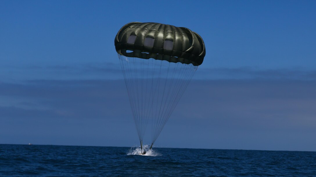 A Marine assigned to Company A, 1st Marine Reconnaissance Battalion, 1st Marine Division, performs a parachute jump into the ocean at Marine Corps Base Camp Pendleton, California, July 14, 2015.  The Marines and Sailors conducted low-level static-line parachute operations with intentional water landings to make insertions, where other means such as boats or high-altitude parachute jumps may not be available.