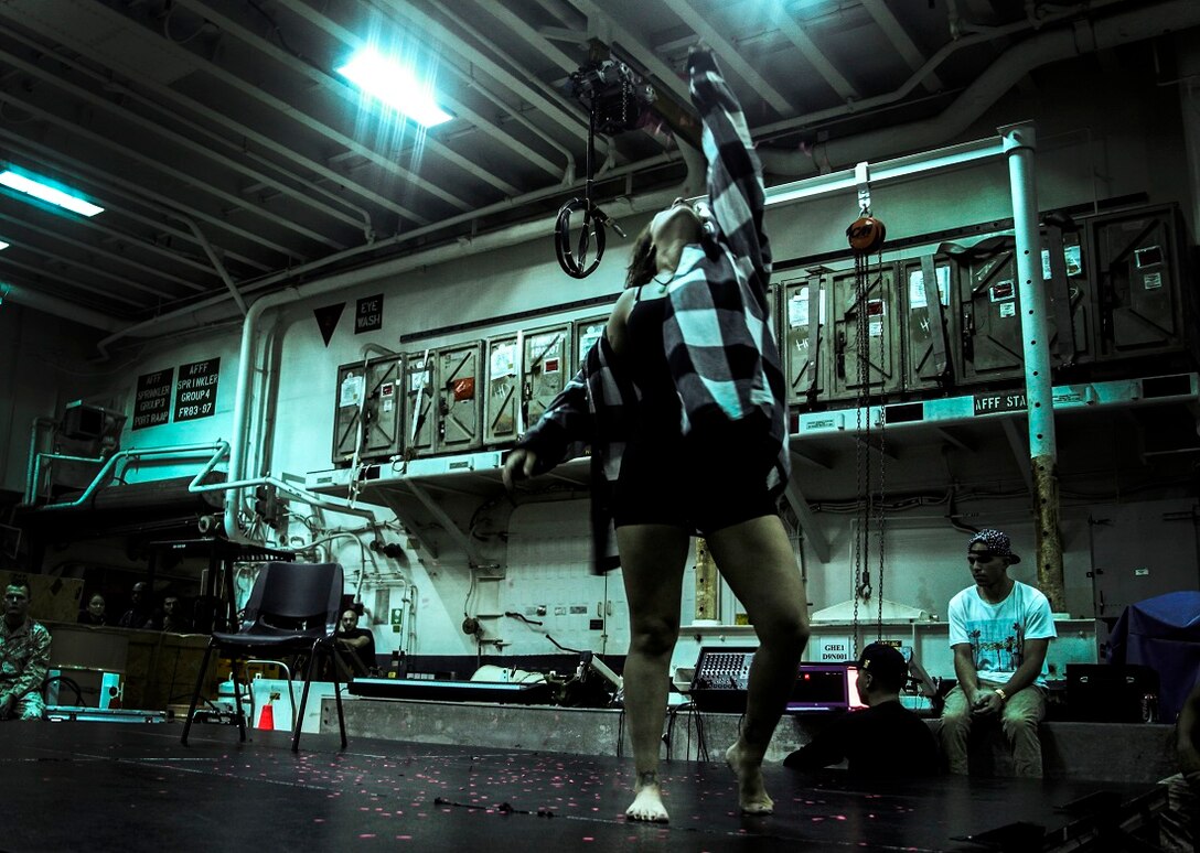 GULF OF ADEN (July 12, 2015) U.S. Navy Avation Boatwain’s Mate (Handling) Mary Schuman performs a contemporary dance during a talent show in the hangar bay of the amphibious assault ship USS Essex (LHD 2). The Essex finds time to enhance unit moral by highlighting Marines and Sailors with the 15th Marine Expeditionary Unit and Essex Amphibious Ready Group’s talents during their deployment. The 15th MEU is embarked on the Essex ARG and deployed to maintain regional security in the U.S. 5th Fleet area of operations. (U.S. Marine Corps photo by Cpl. Elize McKelvey/Released)