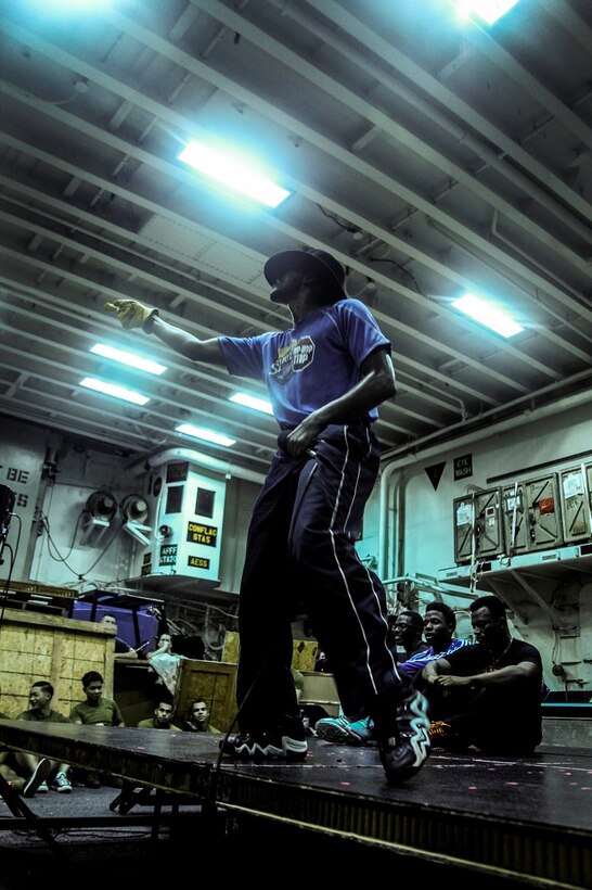 GULF OF ADEN (July 12, 2015) A U.S. Sailor impersonates Michael Jackson’s dance moves during a talent show in the hangar bay of the amphibious assault ship USS Essex (LHD 2). The Essex finds time to enhance unit moral by highlighting Marines and Sailors with the 15th Marine Expeditionary Unit and Essex Amphibious Ready Group’s talents during their deployment. The 15th MEU is embarked on the Essex ARG and deployed to maintain regional security in the U.S. 5th Fleet area of operations. (U.S. Marine Corps photo by Cpl. Elize McKelvey/Released)