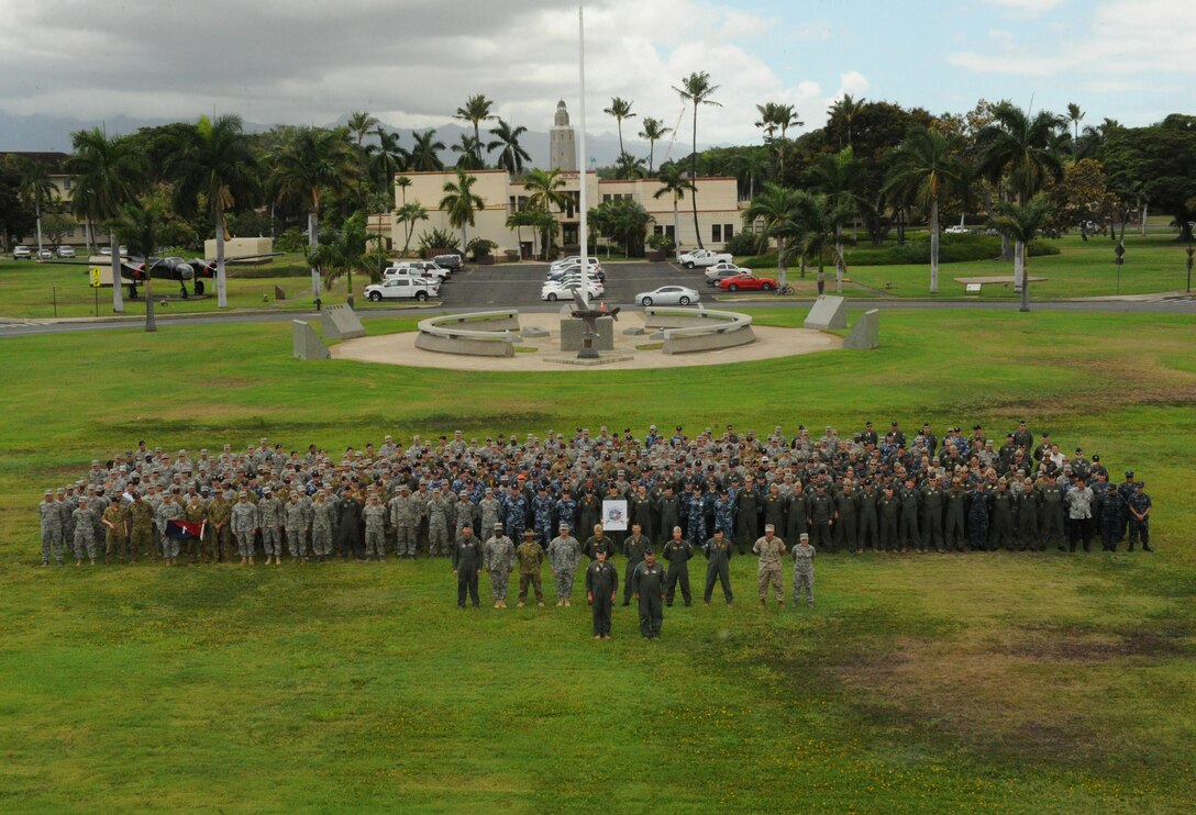 Joint U.S. service members and Royal Australia Air Force personnel pose for a photograph at the close of Talisman Sabre, July 17, 2015, at Joint Base Pearl Harbor-Hickam, Hawaii. Talisman Sabre is a biennial exercise that provides an invaluable opportunity for nearly 30,000 U.S. and Australian defense forces to conduct operations in a combined, joint and interagency environment that will increase both countries’ ability to plan and execute a full range of operations from combat missions to humanitarian assistance efforts. (U.S. Air Force photo by Master Sgt. Matthew Mc Govern/Released)
