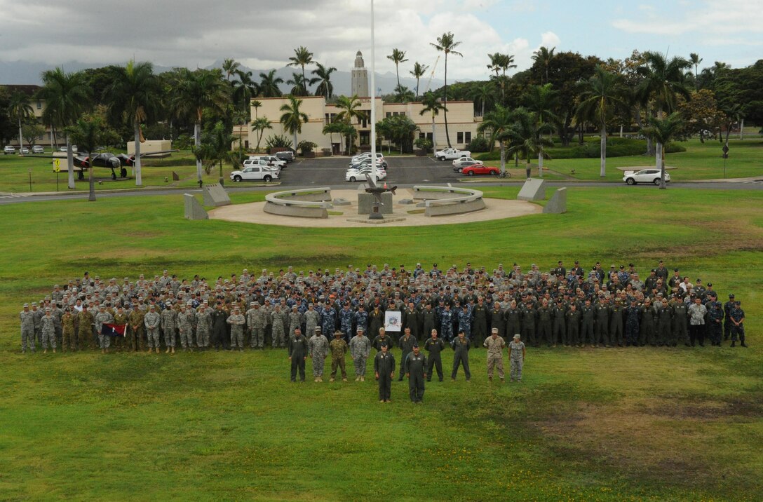 Joint U.S. service members and Royal Australia Air Force personnel pose for a photograph at the close of Talisman Sabre, July 17, 2015, at Joint Base Pearl Harbor-Hickam, Hawaii. Talisman Sabre is a biennial exercise that provides an invaluable opportunity for nearly 30,000 U.S. and Australian defense forces to conduct operations in a combined, joint and interagency environment that will increase both countries’ ability to plan and execute a full range of operations from combat missions to humanitarian assistance efforts. (U.S. Air Force photo by Master Sgt. Matthew Mc Govern/Released)