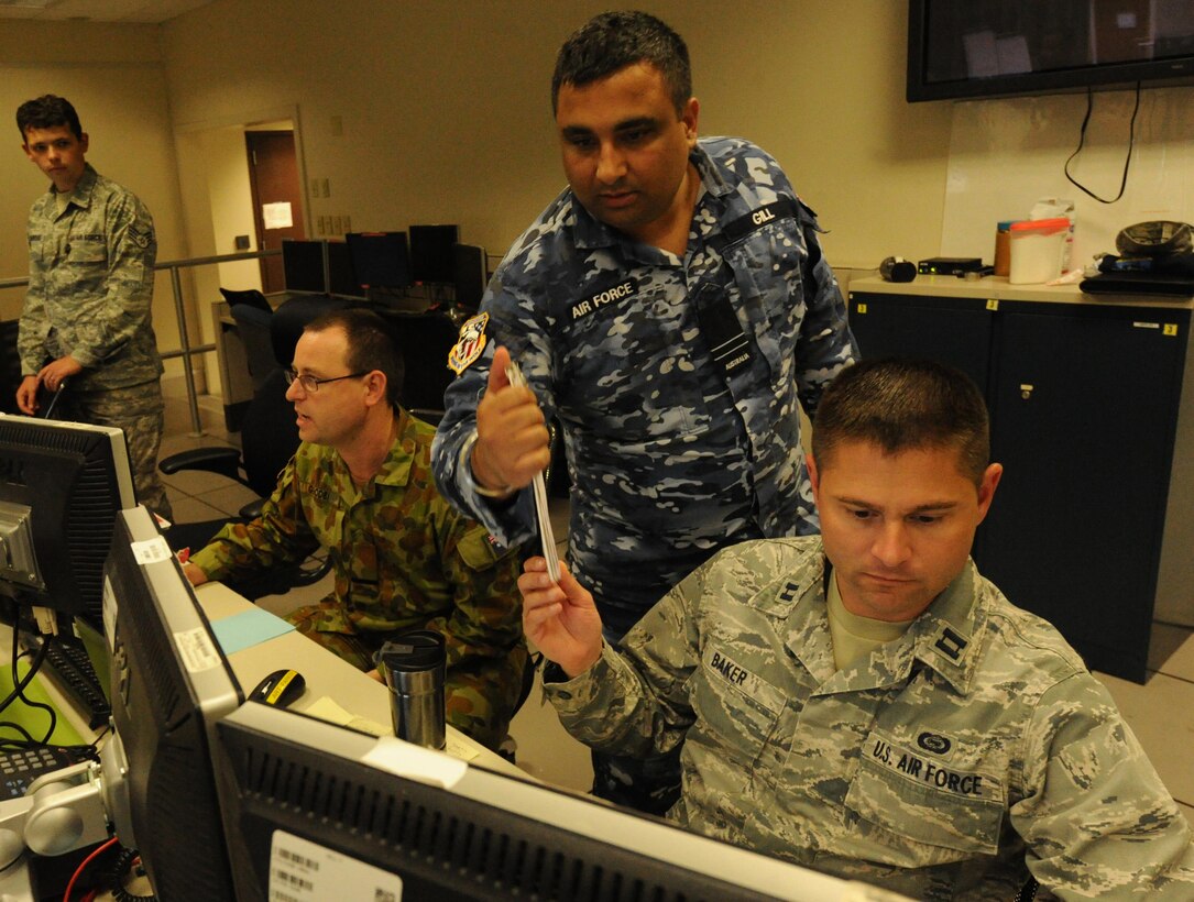 U.S. Air Force Capt. Brenton Baker (right), Royal Australian Air Force Flight Lieutenant Shurumeet Gill and Royal Australian Air Force Flying Officer Chris Goode plan for the next contingency  in the 613th Air Operation Center intelligence surveillance and reconnaissance  section during Talisman Sabre 2015, July 16, 2015, at Joint Base Pearl Harbor-Hickam, Hawaii. Talisman Sabre is a biennial exercise that provides an invaluable opportunity for nearly 30,000 U.S. and Australian defense forces to conduct operations in a combined, joint and interagency environment that will increase both countries’ ability to plan and execute a full range of operations from combat missions to humanitarian assistance efforts. (U.S. Air Force photo by Master Sgt. Matthew Mc Govern/Released)