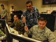 U.S. Air Force Capt. Brenton Baker (right), Royal Australian Air Force Flight Lieutenant Shurumeet Gill and Royal Australian Air Force Flying Officer Chris Goode plan for the next contingency  in the 613th Air Operation Center intelligence surveillance and reconnaissance  section during Talisman Sabre 2015, July 16, 2015, at Joint Base Pearl Harbor-Hickam, Hawaii. Talisman Sabre is a biennial exercise that provides an invaluable opportunity for nearly 30,000 U.S. and Australian defense forces to conduct operations in a combined, joint and interagency environment that will increase both countries’ ability to plan and execute a full range of operations from combat missions to humanitarian assistance efforts. (U.S. Air Force photo by Master Sgt. Matthew Mc Govern/Released)
