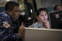 U.S. Air Force Capt. Nicole Vazguez (right), Hawaii Air National Guard command and control duty officer, reviews exercise information with an Australian airman at the 613th Air Operations Center at Joint Base Pearl Harbor-Hickam, Hawaii, as part of Exercise Talisman Sabre 15, July 16, 2015. During the multi-national exercise, U.S. and Australian Airmen teamed up to provide agile, flexible command and control to coalition forces conducting air operations throughout the pacific. (U.S. Air Force photo by Capt. Raymond Geoffroy/Released)