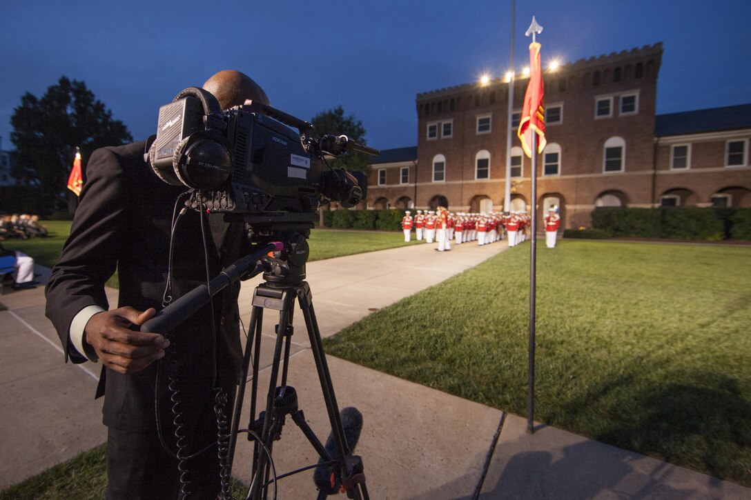 U.S. Marines with Marine Barracks Washington, D.C., perform during an evening parade, July 17, 2015. U.S. Marine Corps Gen. John M. Paxton, assistant commandant of the Marine Corps, was the hosting official for the July 17 evening parade, and the Guest of Honor was Sen. John J. Reed. The Evening Parade summer tradition began in 1934 and features the Silent Drill Platoon, the U.S. Marine Band, the U.S. Marine Drum and Bugle Corps and two marching companies. More than 3,500 guests attend the parade every week. (U.S. Marine Corps Photo by Lance Cpl. Hailey D. Stuart /Released)