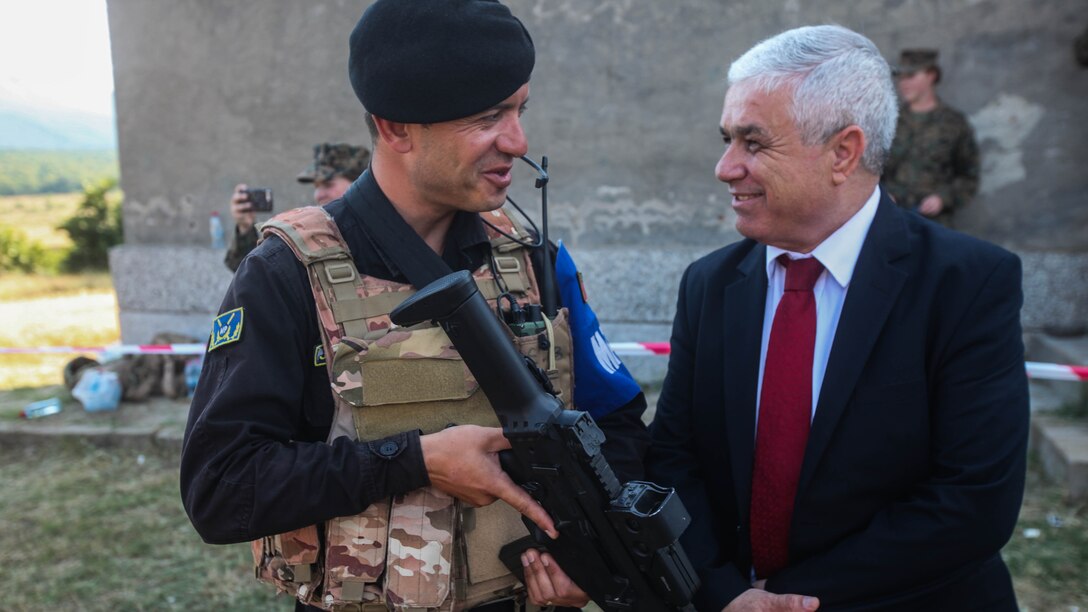 Qirjako Kureta (right), the Albanian Ambassador to Bulgaria, talks with an Albanian soldier during Distinguished Visitors Day at Platinum Lion 15-3. Marines and Sailors with 2nd Battalion, 8th Marine Regiment, Black Sea Rotational Force spent two weeks alongside soldiers from Bulgaria, Albania, United Kingdom and Romania during the multi-national NATO training exercise at Novo Selo Training Area, Bulgaria.