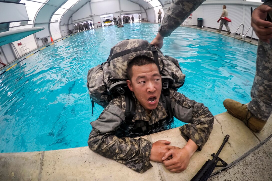 A soldier takes a breather after swimming 25 meters during combat water survival training at Fort Hunter Liggett, Calif., July 17, 2015.