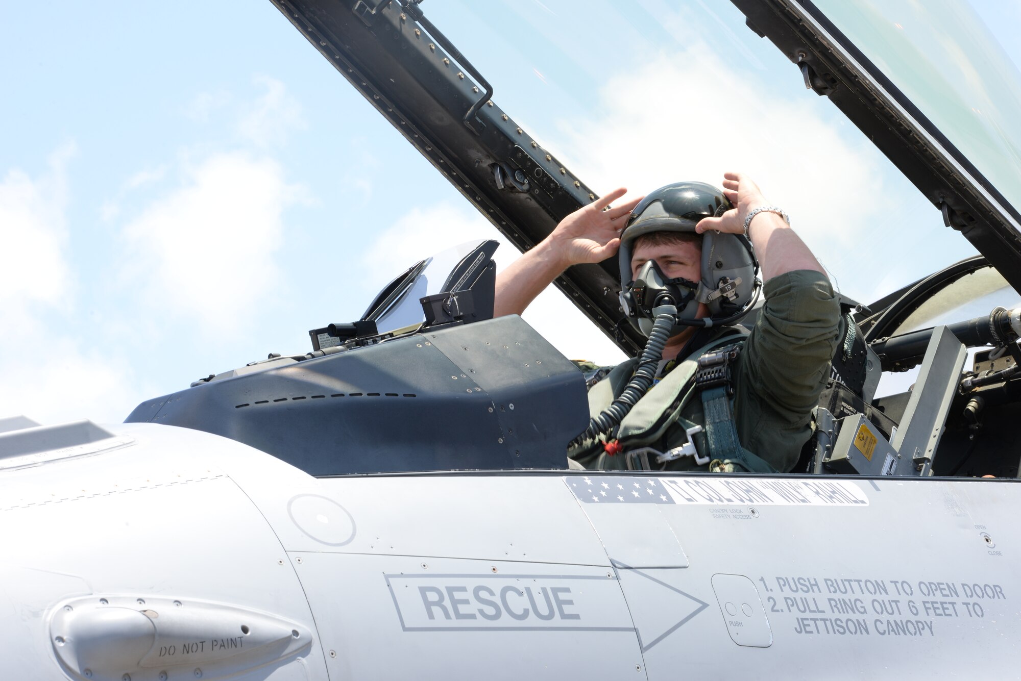 U.S. Air Force 1st Lt. Jonathan Breeze, 158th Fighter Wing fighter F-16 Fighting Falcon pilot, lowers his visor before takeoff on Kadena Air Base, Japan, July 16, 2015. Kadena presents the Vermont Air National Guardsmen unique opportunities to integrate various forces into joint, coalition and bilateral training across diverse environments. (U.S. Air Force photo by Senior Airman Omari Bernard)