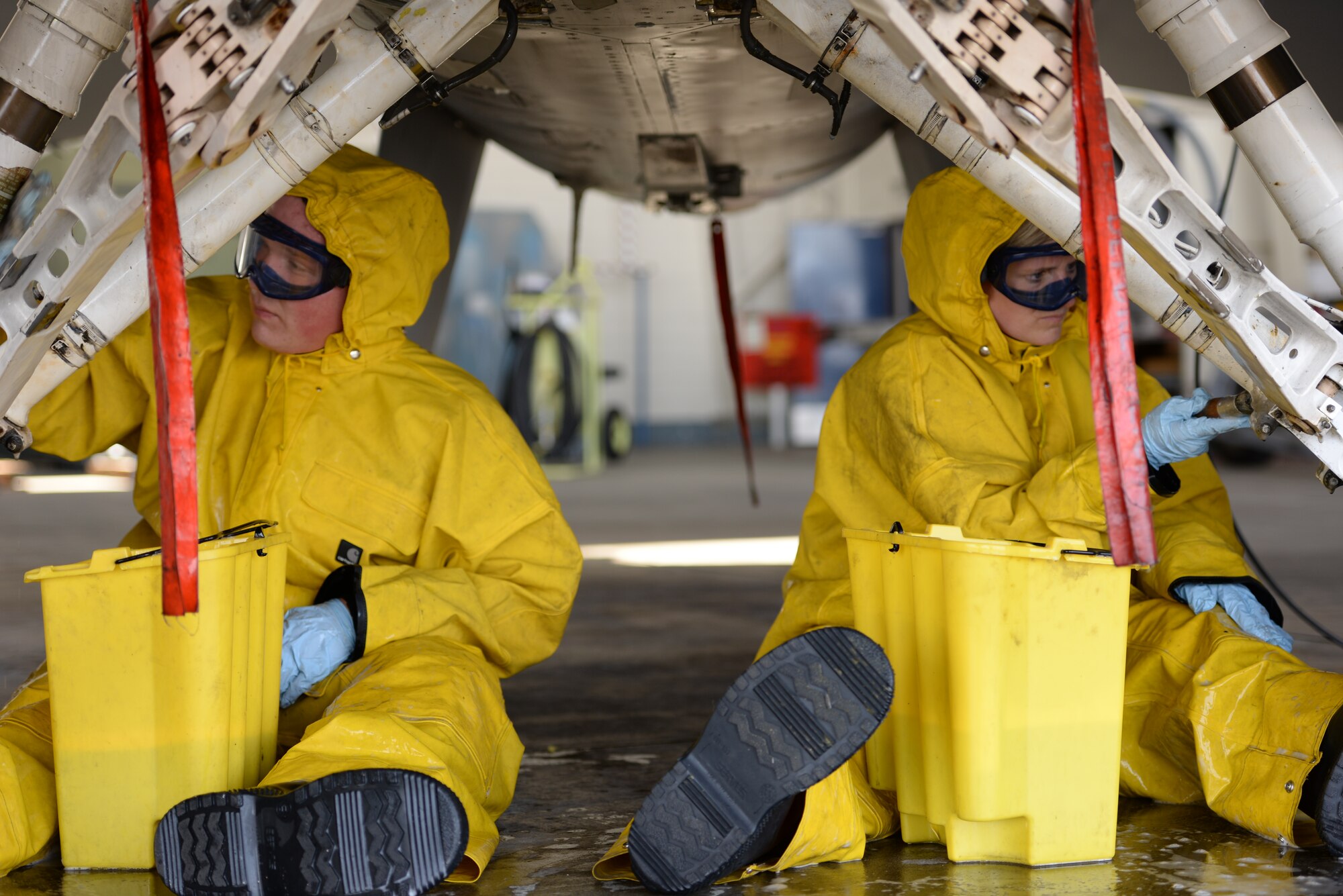 U.S. Air Force Airman 1st Class Brandon Root (left) and Senior Airman Christine Jaques, 158th Fighter Wing aircraft fuels systems apprentices, wash the landing gear of an F-16 Fighting Falcon on Kadena Air Base, Japan, July 16, 2015. Maintainers work around the clock to ensure their aircraft are safe for their pilots and can continue the mission. The 158th FW from the Vermont Air National Guard, also known as the Green Mountain Boys, are currently deployed to Kadena to enhance regional security in the Indo-Asia-Pacific region and demonstrate the U.S. commitment to stability in the region. (U.S. Air Force photo by Senior Airman Omari Bernard)