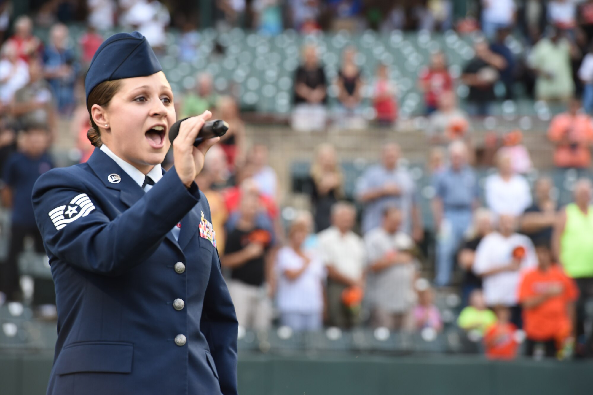 Tech. Sgt. Karen Blackburn, 11th Wing Command Post controller, sings the national anthem for the Bowie Baysox baseball game at Bowie, Md., Friday, July 17, 2015. Military members were invited to participate in pre-game events in honor of military appreciation night. (U.S. Air Force Photo/Senior Airman Joshua R. M. Dewberry)