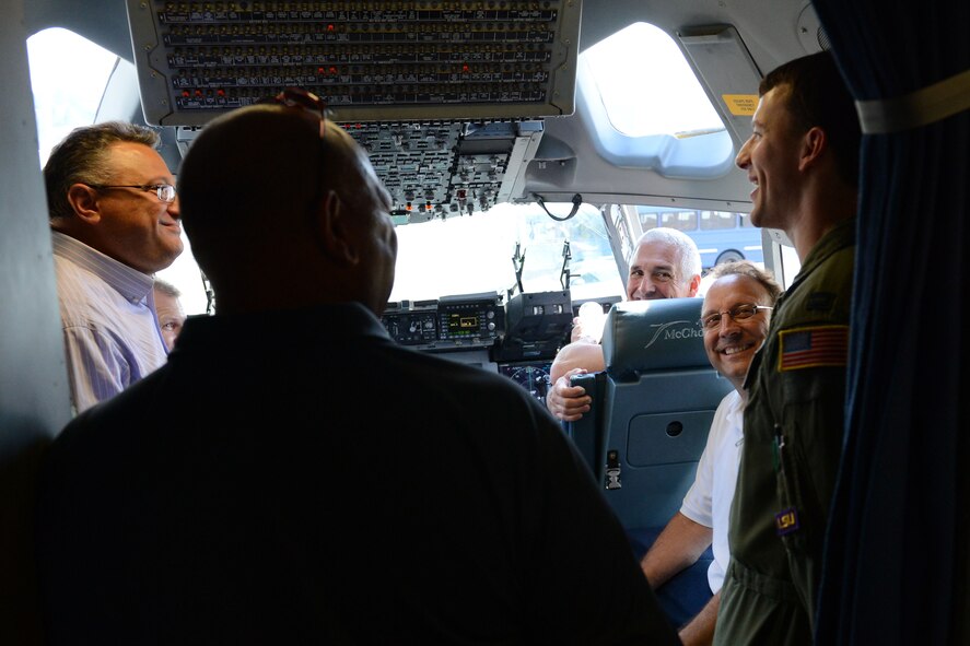 Capt. Marc Daigle, 8th Airlift Squadron pilot, facilitates a tour of the flight deck of a C-17 Globemaster III aircraft with members of the United Parcel Service Northwest Division during their tour of Joint Base Lewis-McChord, Wash., July 16, 2015. During their tour of JBLM, the UPS Northwest Division members also visited the American Lake Conference Center, the Mission Training Complex, the Engagement Skills Trainer and Dismount Soldier Training Suite, the 2nd Battalion, 1st Infantry Regiment Motorpool, and a Stryker static configuration and individual body armor display. (U.S. Air Force photo/ Staff Sgt. Katie Jackson)