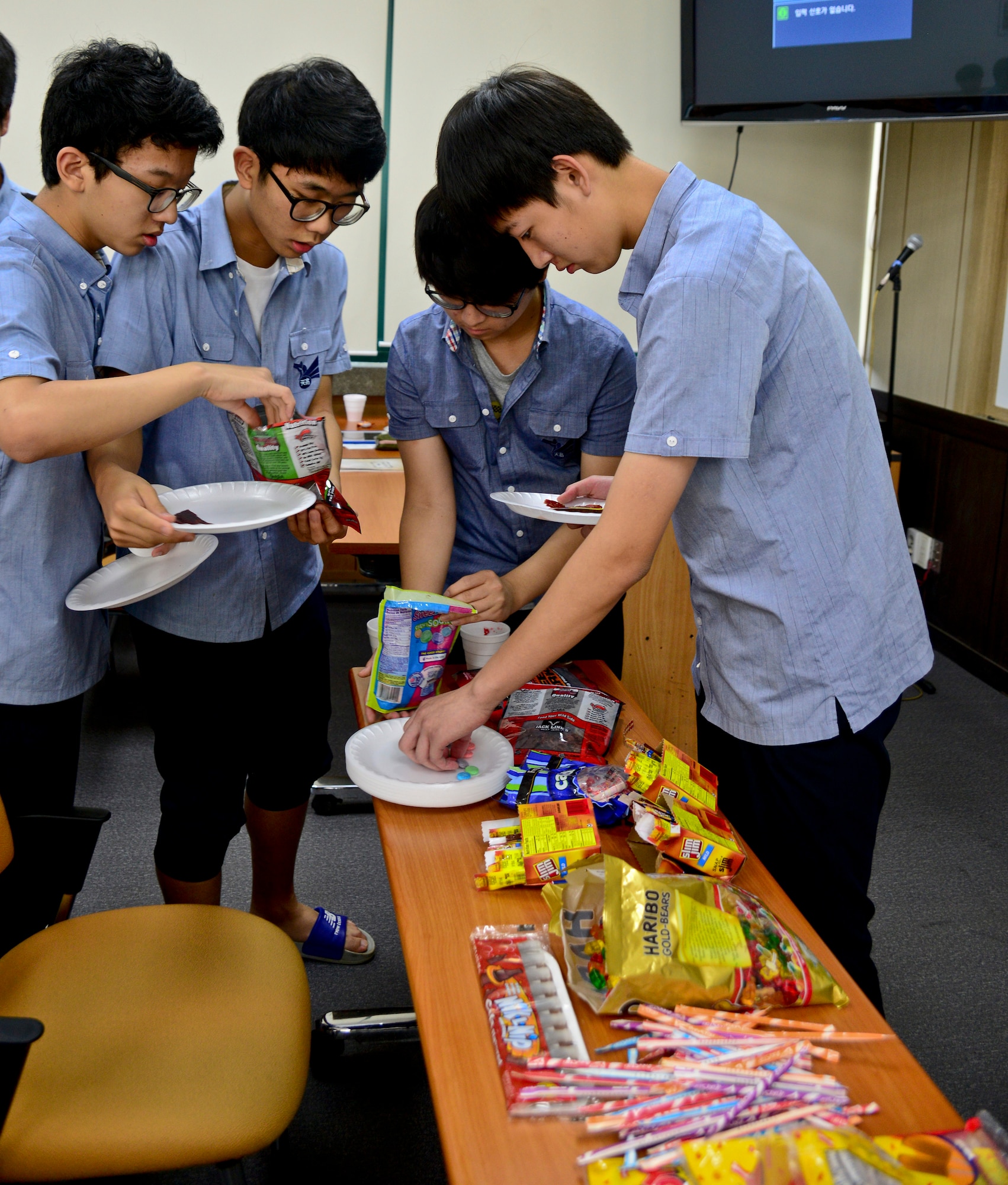 Students from Cheonan High School, Cheonan, South Korea, gather American snacks to try July 10, 2015. The students of the podcast club, “Channel K Radio," tried various American snacks during an international cultural exchange between Cheonan and Warren Academy, McMinnville, Tenn. (U.S. Air Force photo/Senior Airman Kristin High)