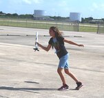 Kayla Adkins, daughter of Master Sgt. Helen Adkins, a training and logistics readiness manager at the 149th Fighter Wing, catches her model rocket after a successful launch on the final morning of her week-long class at DoD STARBASE-Kelly at Joint Base San Antonio-Lackland, Texas on July 17, 2015. Kayla, along with 19 other students, successfully launched their rockets that morning. (U.S. Air Force photo/Tech. Sgt. Carlos J. Trevino) 

