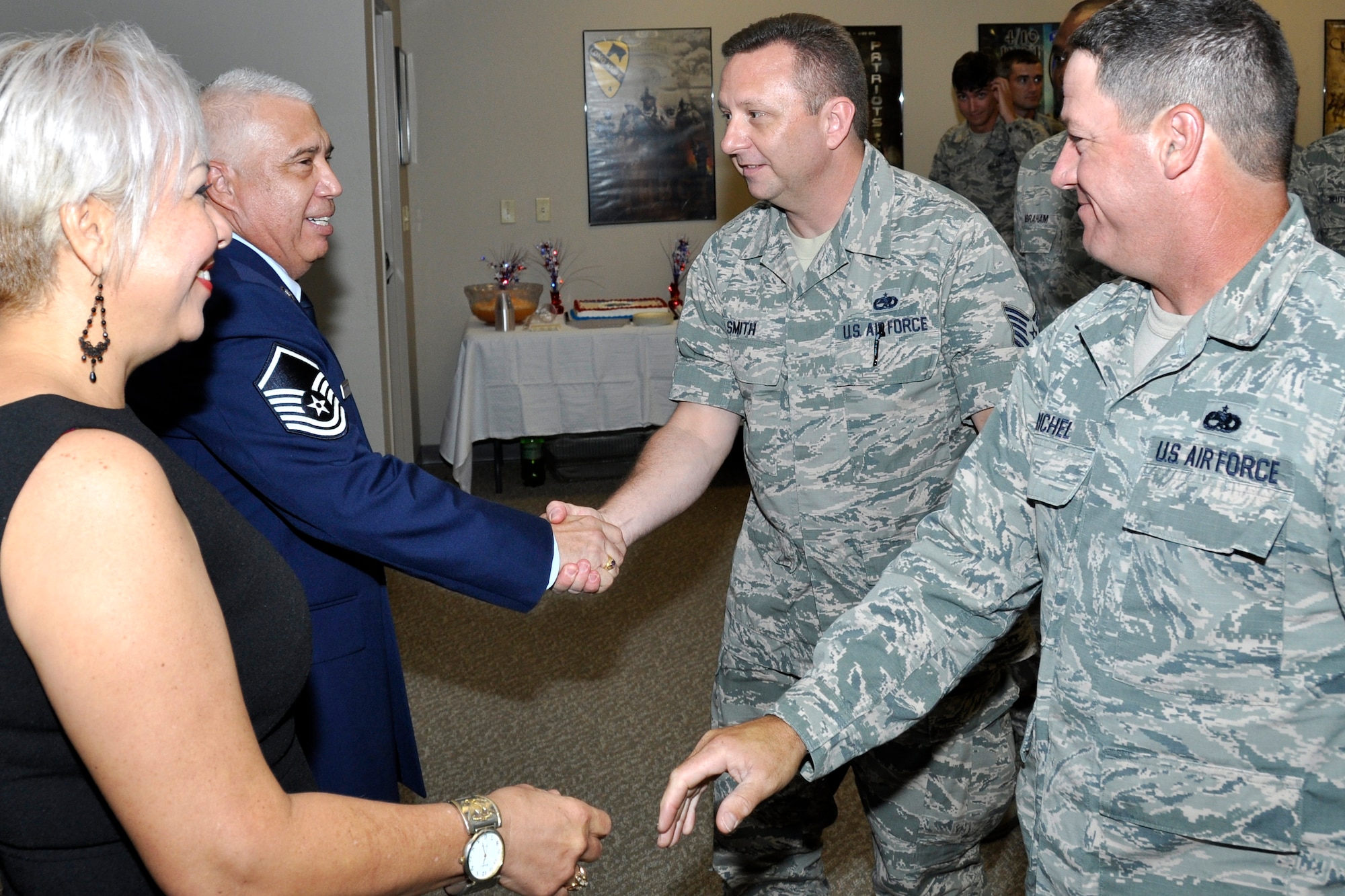 U. S. Air Force Master Sgt. Jose Garcia, 307th Aircraft Maintenance Squadron mechanic, and his wife, Zaida, visit with well-wishers after his retirement ceremony at Barksdale Air Force Base, La., July 11, 2015.   Garcia retired with more than twenty years of service. (U.S. Air Force photo by Tech. Sgt. Ted Daigle/Released)