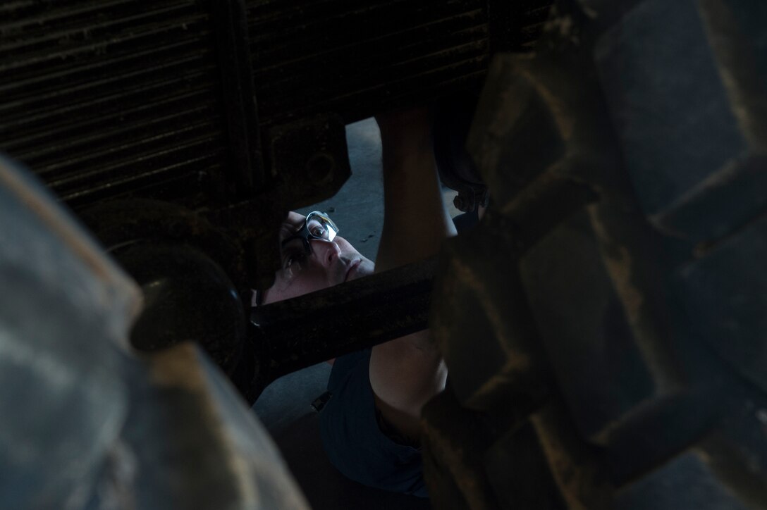 U.S. Air Force Tech. Sgt. Dana Fox, 7th Logistic Readiness Squadron fire truck and refueling maintenance non-commissioned officer in charge, works on an airbrake system beneath the View Volunteer Fire Department brush fire truck July 30, 2015, at Dyess Air Force Base, Texas. According to the 7th LRS commander, the project benefits the community by providing support to a part of the local community that may not otherwise be able to afford it; however, he believes the bigger impact lies in what the Airmen took away from working on the vehicle: experience. (U.S. Air Force photo by Senior Airman Peter Thompson/Released)