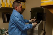 Senior Airman Luis Poblano, 5th Medical Support Squadron laboratory technician, prepares a blood sample for testing at Minot Air Force Base, N.D., July 8, 2015. Poblano is one of only two Airmen working at the lab. (U.S. Air Force photo/Airman 1st Class Christian Sullivan)