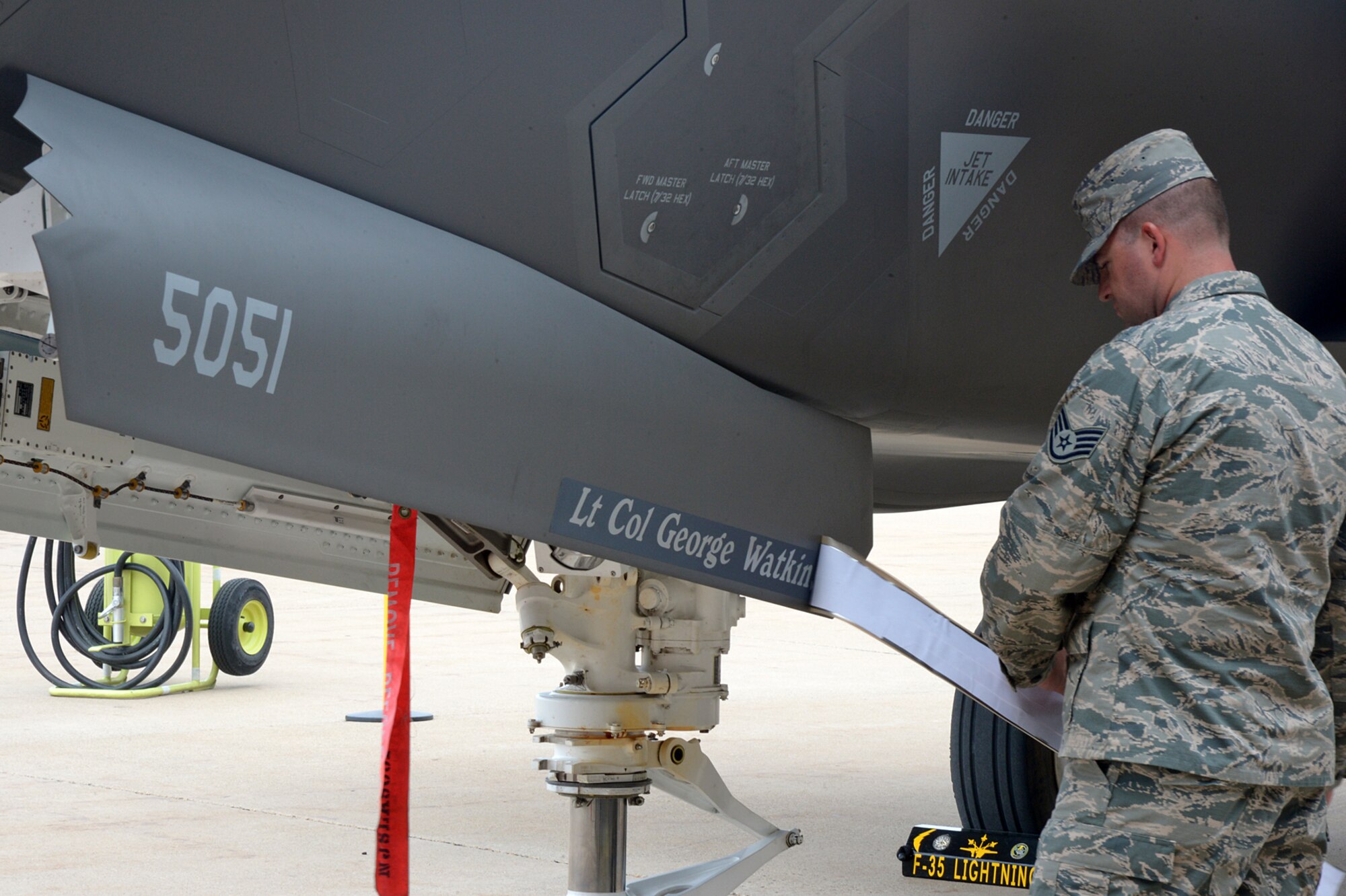 Staff Sgt. Bryan Jernigan, a dedicated crew chief assigned to the 388th Aircraft Maintenance Squadron, reveals the name on an F-35A aircraft of the 34th Fighter Squadron's new commander, Lt. Col. George R. Watkins,  during the squadron’s activation ceremony July 17 at Hill Air Force Base, Utah. The 34th will be the first combat squadron to fly the Air Force’s newest fighter aircraft, the F-35A. The squadron has an extremely rich history. After many contributions in major U.S. conflicts, the 34th was relocated to Hill AFB on Dec. 8, 1975, where they became the first fighter squadron to receive the F-16 fighter aircraft. The squadron’s first F-35A will arrive in September.  (U.S. Air Force photo by Alex R. Lloyd/Released)