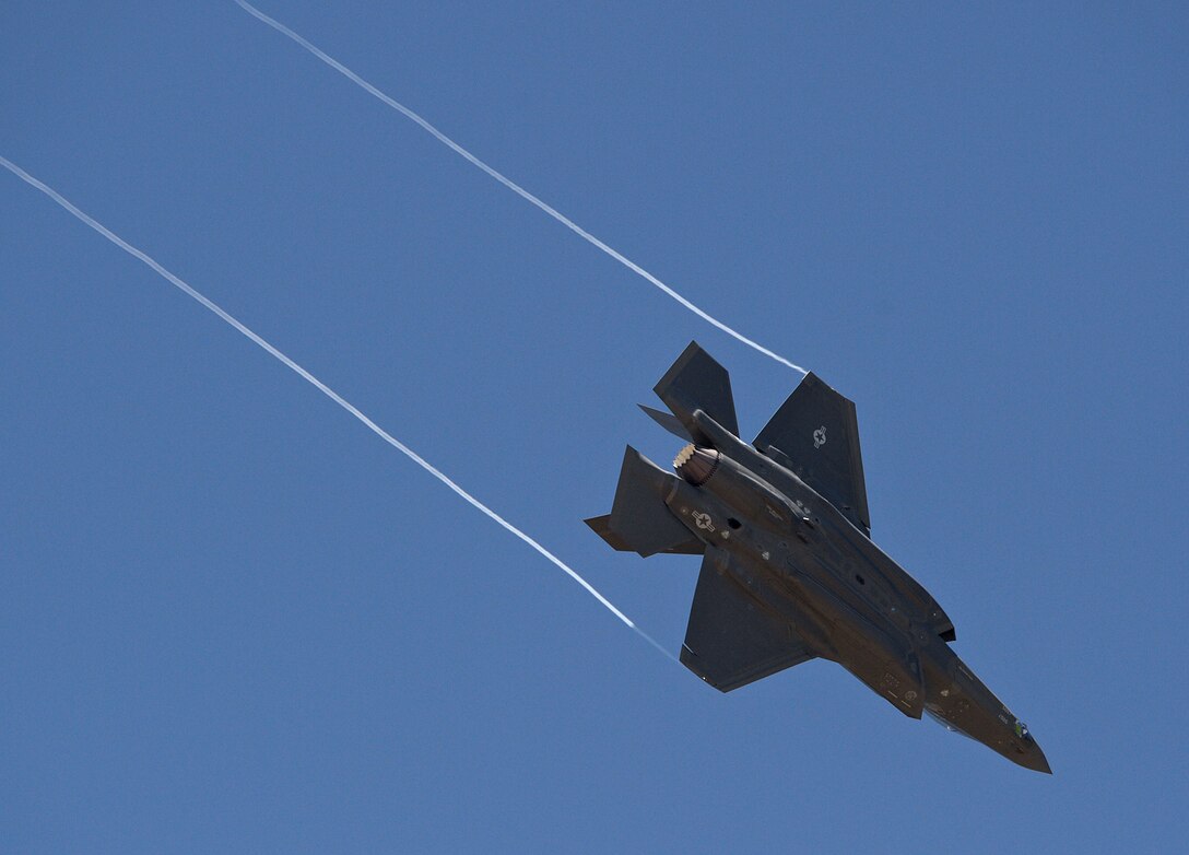 An F-35A Lightning II aircraft from Luke Air Force Base, Ariz., breaks hard left trailing wingtip vortexes behind as it arrives at Hill Air Force Base, Utah, where it will be seen on static display during the 34th Fighter Squadron’s activation ceremony July 17 at Hill AFB. The 34th will be the first combat squadron to fly the Air Force’s newest fighter aircraft, the F-35A. The squadron has an extremely rich history. After many contributions in major U.S. conflicts, the 34th was relocated to Hill AFB on Dec. 8, 1975, where they became the first fighter squadron to receive the F-16 fighter aircraft. The squadron’s first F-35A will arrive in September.  (U.S. Air Force photo by Alex R. Lloyd/Released)