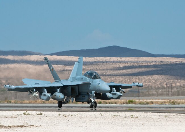 An EA-18G Growler assigned to Electronic Attack Squadron 138, Naval Air Station Whidbey Island, Wash., lands on the runway after returning from a Red Flag 15-3 sortie at Nellis Air Force Base, Nev., July 17, 2015. Red Flag is a realistic combat exercise involving U.S. and allied air forces conducting training operations on the 15,000 square mile Nevada Test and Training Range. (U.S. Air Force photo by Airman 1st Class Jake Carter)