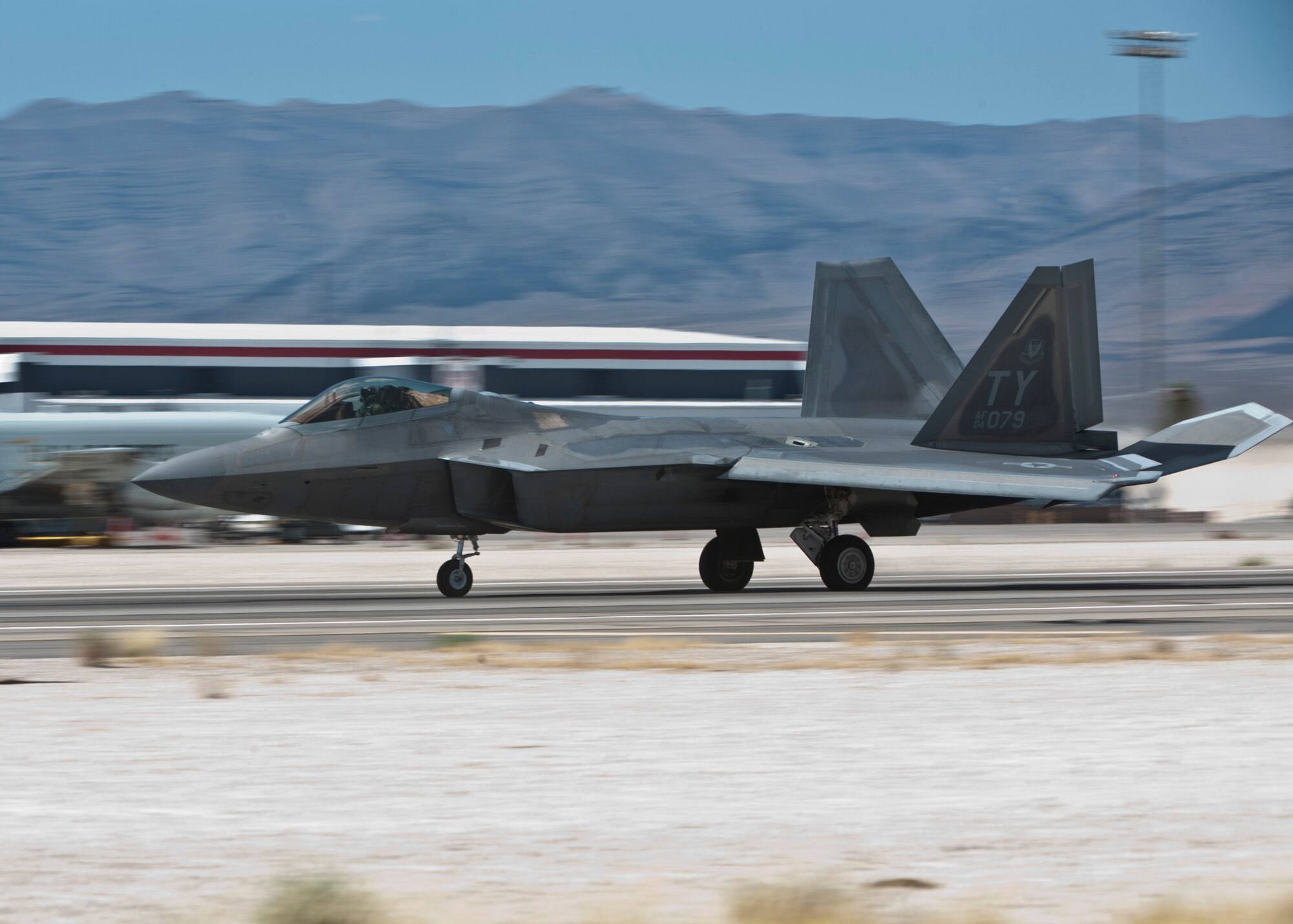 An F-22 Raptor assigned to the 95th Fighter Squadron, Tyndall Air Force Base, Fla., lands on the runway after returning from a Red Flag 15-3 sortie at Nellis AFB, Nev., July 17, 2015. Red Flag is a realistic combat exercise involving U.S. and allied air forces conducting training operations on the 15,000 square mile Nevada Test and Training Range during day and night operations. (U.S. Air Force photo by Airman 1st Class Jake Carter)