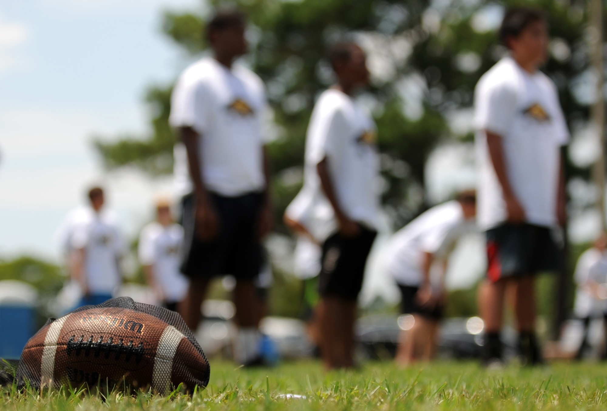 Young athletes line up for a passing drill during a National Football League ProCamp, July 16, 2015, at Seymour Johnson Air Force Base, North Carolina. Cortez Allen, Pittsburgh Steelers defensive back, was the featured NFL player during the two-day camp. (U.S. Air Force photo/Senior Airman Ashley J. Thum)