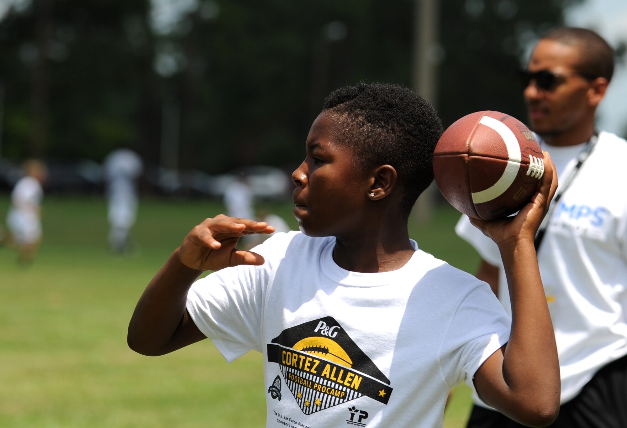 A “future quarterback” cocks his arm back during a National Football League ProCamp, July 16, 2015, at Seymour Johnson Air Force Base, North Carolina. Cortez Allen, Pittsburgh Steelers defensive back, was the camp’s guest athlete. (U.S. Air Force photo/Senior Airman Ashley J. Thum)