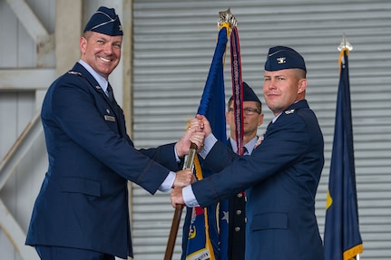 Colonel Robert Lyman (left), Joint Base Charleston commander, passes the 628th Mission Support Group guidon to incoming commander, Col. Richard Mathews (right), during the 628th MSG change of command, July 17, 2015 at Joint Base Charleston, SC.  Matthews assumed command of the 628th MSG from Col. Michael Mongold during the ceremony. Matthews comes to JB Charleston from Air Mobility Command at Scott Air Force Base, Ill,, where he was chief, Engineering Division Direcotrate of Instllations and Mission Support. Mongold is headed to the Air Force Personnel Center at Joint Base San Antonio – Randlolph, Texas, where he will serve as the chief of the Air Expeditionary Forces Operations Squadron.  (U.S. Air Force photo/ Airman 1st Class Thomas T. Charlton)