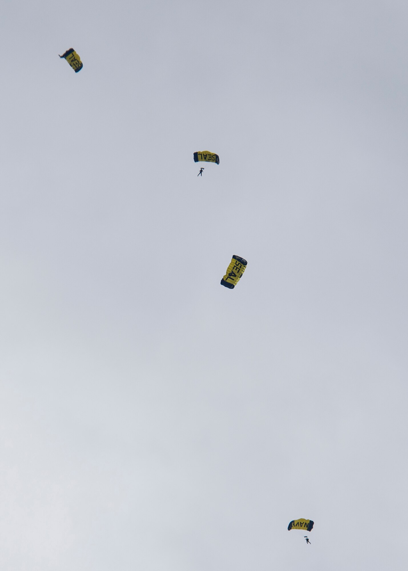 The Leap Frogs, the U.S. Navy parachute team, guide themselves toward a landing zone on F.E. Warren Air Force Base, Wyo., July 18, 2015. They landed on the Argonne Parade field in front of a cheering crowd visiting F.E. Warren for Fort D.A. Russell Days, the base's annual open house. (U.S. Air Force photo by Senior Airman Jason Wiese)