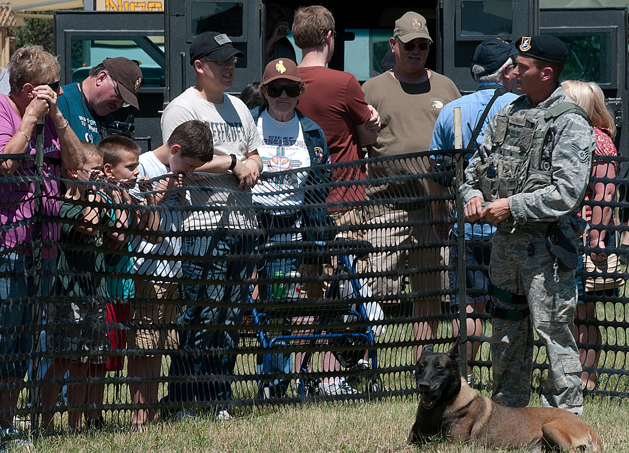 Staff Sgt. Stephen Showmaker, 90th Security Forces Squadron military working dog handler, speaks with audience members, July 17, 2015, during the F.E. Warren Air Force Base, Wyo., base open house, Fort D.A. Russell Days. Showmaker and military working dog Lasso, a six-year-old Belgium Malines, demonstrated how the military working dogs assist security forces Airmen to accomplish the mission. The military working dog section will perform one more demonstration during Fort D.A. Russell Days on Sunday, July 19, 2015. (U.S. Air Force photo by Airman 1st Class Brandon Valle)