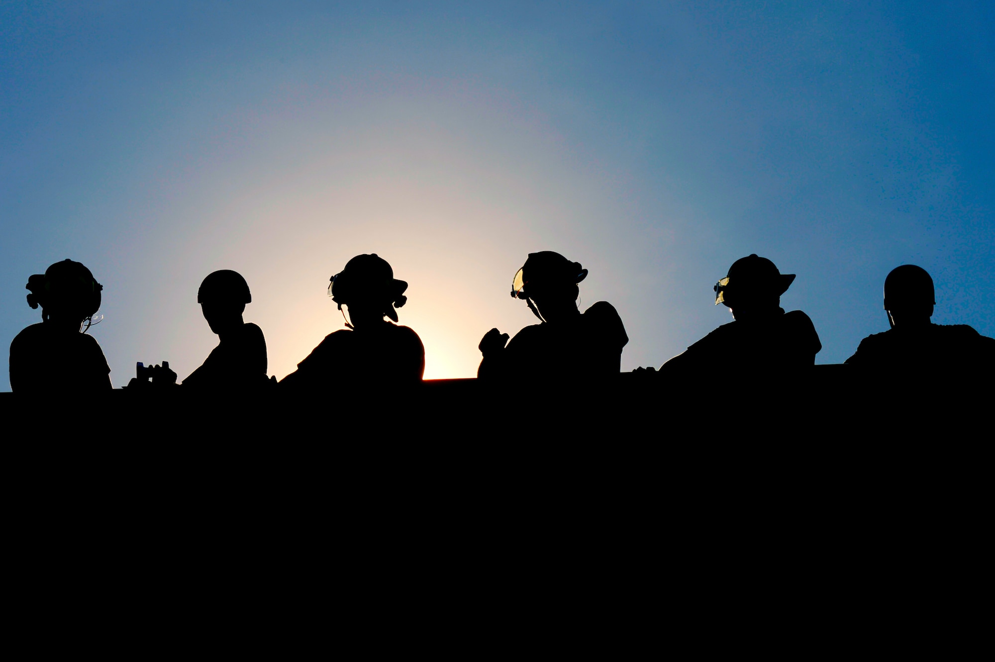 Shaw and Sumter Fire Department firefighters stand atop the structural burn tower at the fire training grounds, Shaw Air Force Base, S.C., July 20, 2015. Firefighters practiced high-angle rope training, repelling down the tower to simulate a rescue. (U.S. Air Force photo by Jensen Stidham/Released)