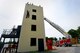 Members of the Sumter and Shaw Fire Departments conduct  joint-training at the structural burn tower at Shaw Air Force Base, S.C., July 13, 2015. During the second of three joint-training sessions with Sumter firefighters, the Shaw Fire Department strengthened their relationship with Sumter firefighters, becoming a more efficient team. (U.S. Air Force photo by Senior Airman Jensen Stidham/Released)