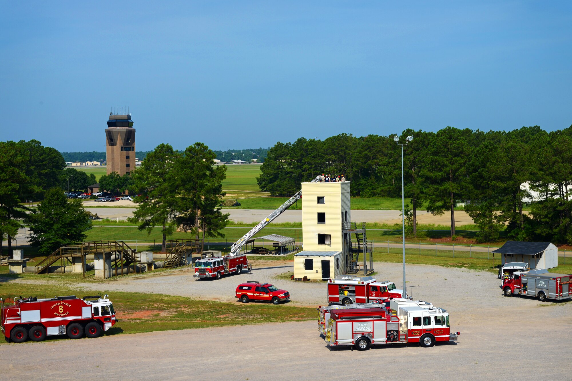 Shaw and Sumter Fire Department firefighters  conduct joint high-angle rope training with at the fire training grounds, Shaw Air Force Base, S.C., July 13, 2015. The joint-training was used to develop and hone the techniques used by firefighters of all skill-levels.  (U.S. Air Force photo by Senior Airman Jensen Stidham/Released)