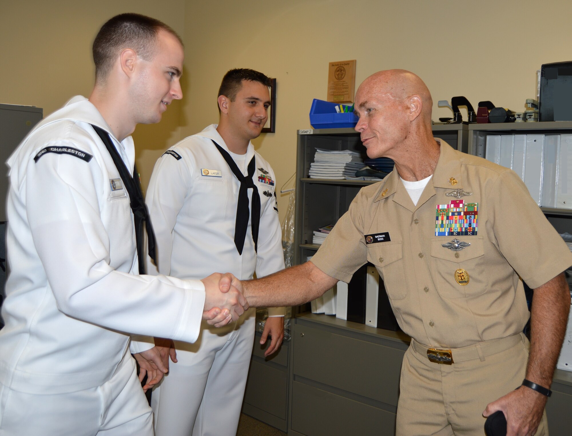 Petty Officer 2nd Class Michael Prunty (left) and Petty Officer 3rd Class
Gregory Lafer, hospital corpsmen at Naval Health Clinic Charleston, Joint Base Chareston, S.C., greet Force Master Chief Sherman Boss, director of the Navy Hospital Corps, July
17, 2015 as Boss toured NHCC during his visit to Joint Base Charleston. (Navy photo by Hospitalman Adrienne Quinter)
