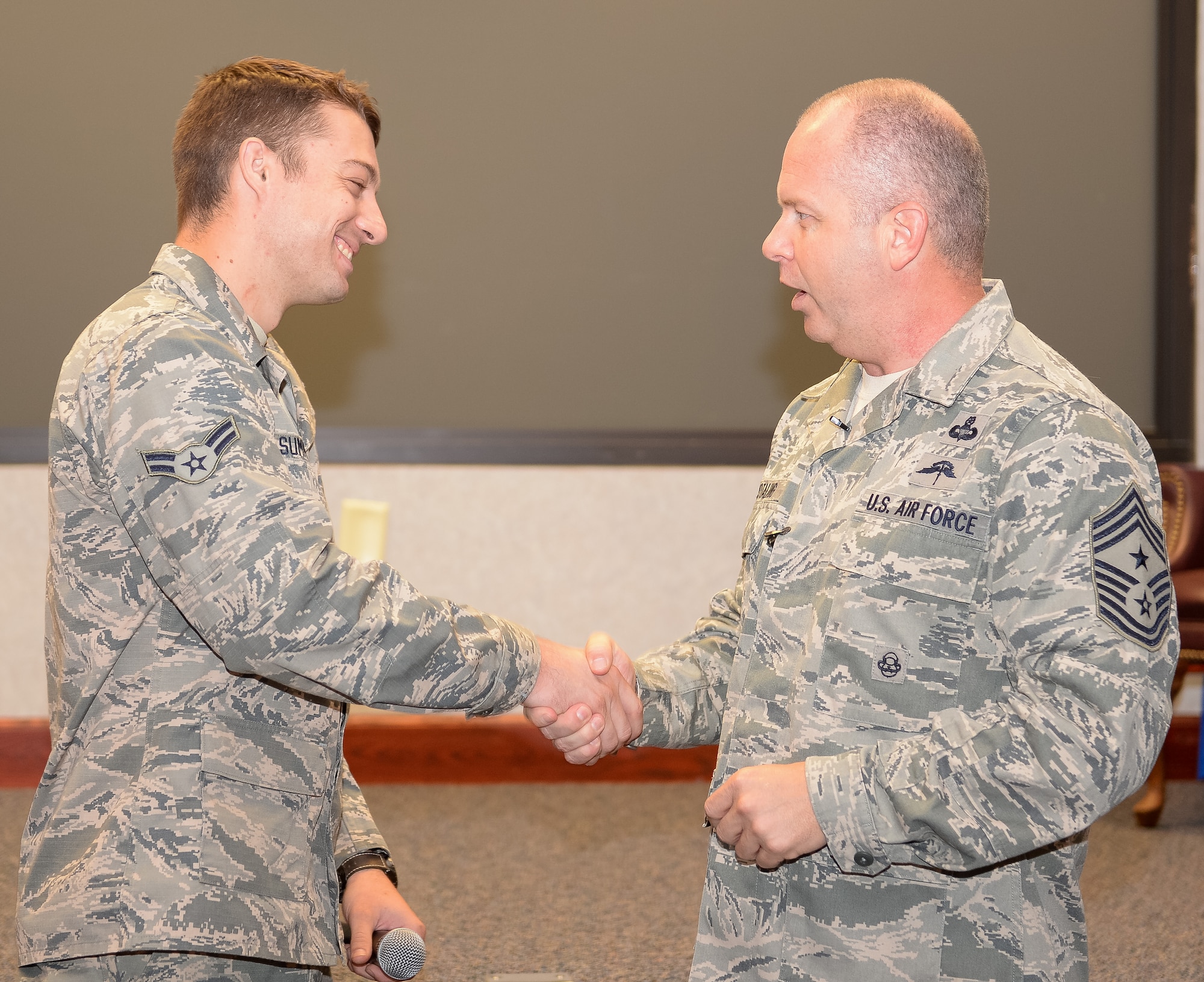 U.S. Air Force Chief Master Sgt. James W. Hotaling, Air National Guard command chief, recognizes Airman 1st Class Caleb Summers, 116th Maintenance Squadron, Georgia Air National Guard, as being one of the 116th Air Control Wing’s newest Guardsman during an enlisted all call at Robins Air Force Base, Ga., July 16, 2015. During his visit, Hotaling conducted two town hall style meetings and met with key enlisted leadership councils and Airmen resiliency representatives. His time with the Airmen focused on sharing his message of a renewed commitment to the profession of arms, health of the force, and recognition of our Airmen and accomplishments. The visit offered the opportunity for Airmen in the wing to meet their top leader, share their concerns and gain perspective from the national level. (U.S. Air National Guard photo by Tech. Sgt. Regina Young/Released)