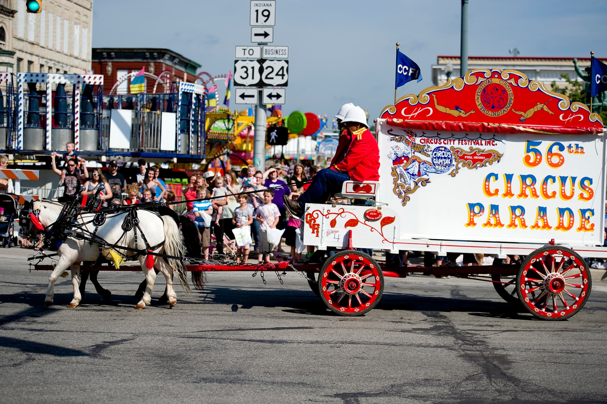 A wagon turns the corner from Main onto Broadway in Peru, Ind., July 18, 2015 during the city's 56th circus parade. Col. Doug Schwartz, 434th Air Refueling Wing commander participated in the parade representing the men and women of Grissom Air Reserve Base, Ind.  (U.S. Air Force photo/Tech. Sgt. Douglas Hays)