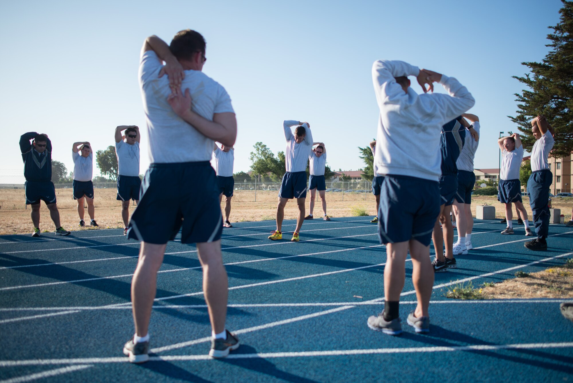 Airmen from the 921st Contingency Response Squadron stretch as they wrap up their twice-weekly physical training July 15, 2015 at Travis Air Force Base, California. Doctors recommend moderate stretching before and after exercise to help improve the range of motion of joints and boost circulation. (U.S. Air Force photo/Ken Wright)
