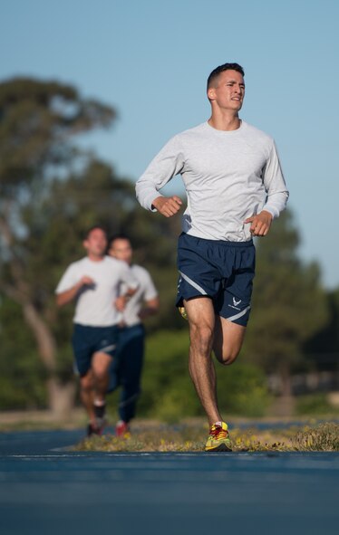 Senior Airman Corey Andersen, 921st Contingency Response Squadron crew chief, makes a strong finish during his unit's physical training July 15, 2015. Andersen leads PT twice per week, guiding and encouraging fellow Airmen through strenuous cardiovascular exercise. (U.S. Air Force photo/Ken Wright)
