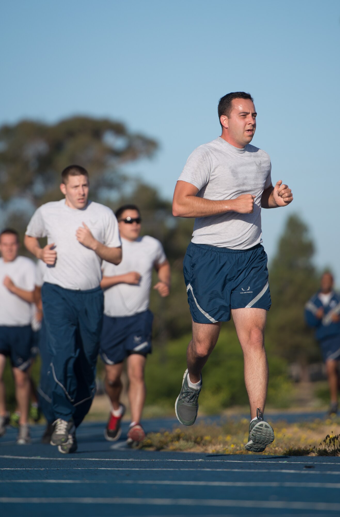 Tech. Sgt. Justin Stanko, 921st Contingency Response Squadron aerial port team member, makes a final stride at the end of his unit's physical training July 15, 2015 at Travis Air Force Base, California. (U.S. Air Force photo/Ken Wright)
