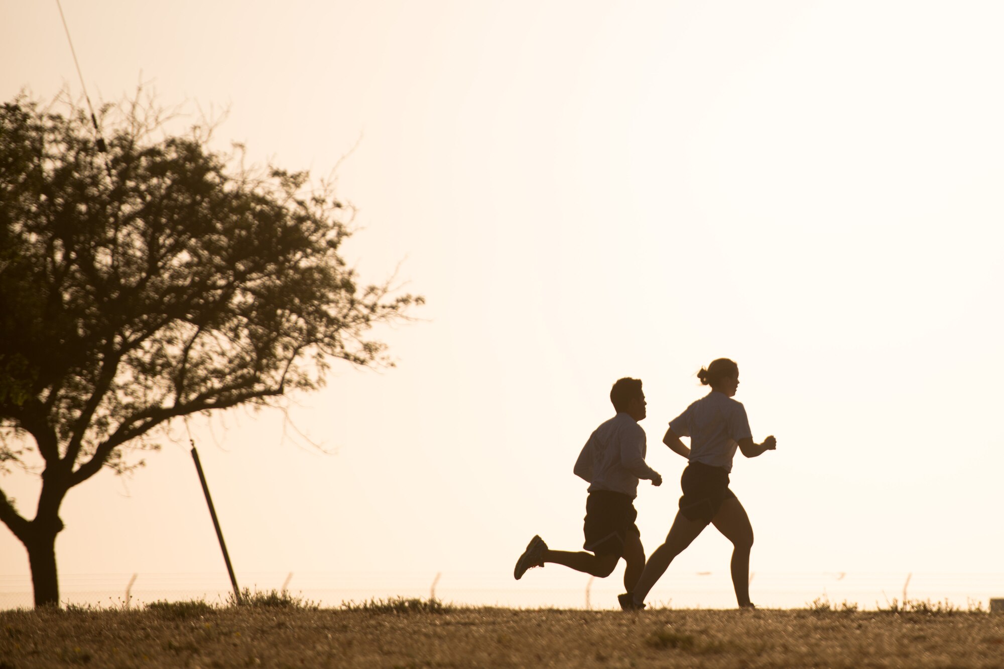 Airmen from the 921st Contingency Response Squadron run laps around a track early July 15, 2015 during their unit's twice-weekly physical training at Travis Air Force Base, California. With a high operations tempo, physical fitness is key to Airmen maintaining resiliency. They Mayo Clinic suggests that coupled with a healthy diet and 7-8 hours of uninterrupted nightly sleep, an active lifestyle can help reduce stress and lead to a healthier and longer life. (U.S. Air Force photo/Ken Wright)