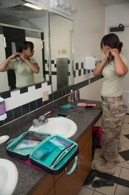 Senior Airman Jessica Flores, 91st Missile Security Forces Squadron flight security controller, prepares for her shift at Bravo-01 Missile Alert Facility near Ruso, N.D., July 1, 2015. Flores typically works a 12-hour night shift at the MAF, controlling access to the building as well as the launch control center alongside one other FSC.  (U.S. Air Force photo/Senior Airman Stephanie Morris)