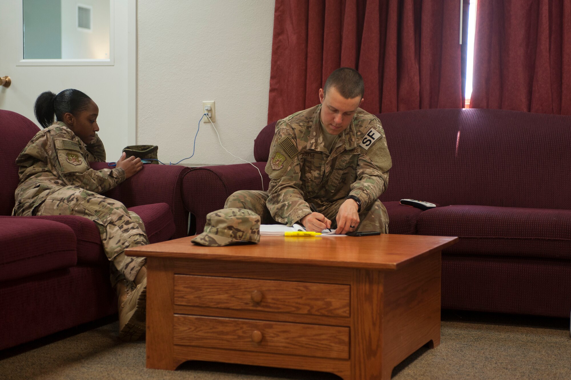 Senior Airman Sierra Jackson(left), and Airman 1st Class Brett Payne, 91st Missile Security Forces Squadron fire team members, use their down time to study and read at the Bravo-01 Missile Alert Facility near Ruso, N.D., July 1, 2015. 91st MSFS members spend four days at their assigned MAFs working 12-hour shifts. However, when they are not on duty they are able to utilize the MAF’s fitness room, study and recreation area or the available pool table. (U.S. Air Force photo/Senior Airman Stephanie Morris)