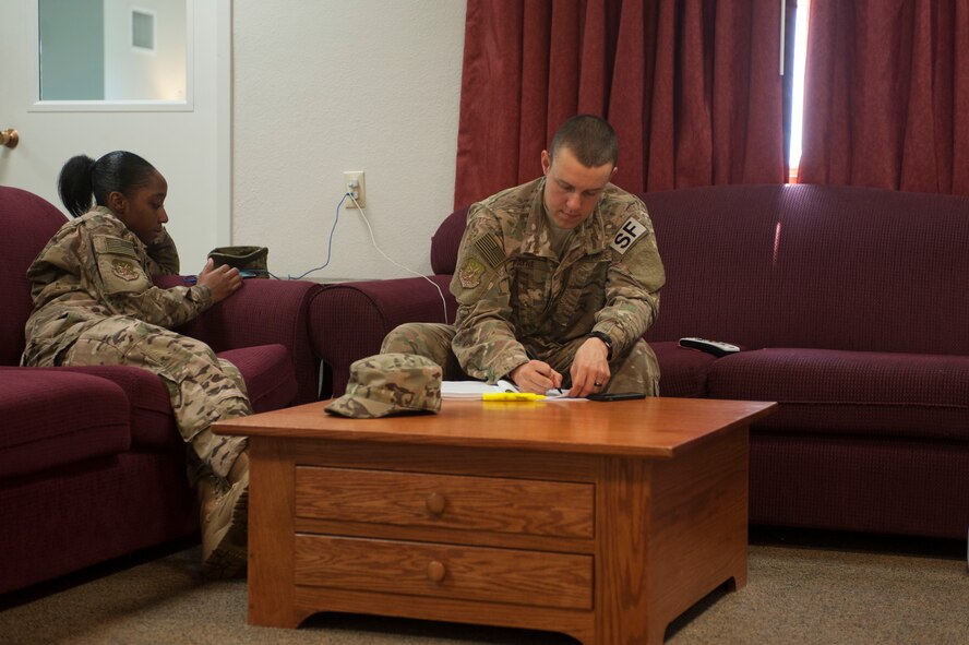Senior Airman Sierra Jackson(left), and Airman 1st Class Brett Payne, 91st Missile Security Forces Squadron fire team members, use their down time to study and read at the Bravo-01 Missile Alert Facility near Ruso, N.D., July 1, 2015. 91st MSFS members spend four days at their assigned MAFs working 12-hour shifts. However, when they are not on duty they are able to utilize the MAF’s fitness room, study and recreation area or the available pool table. (U.S. Air Force photo/Senior Airman Stephanie Morris)