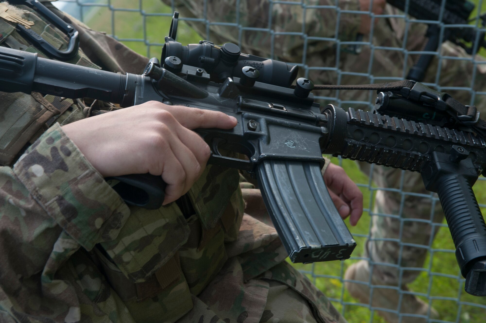 Airman 1st Class Gibran Hernandez, 91st Missile Security Forces Squadron fire team member, rests his trigger finger against the side of his M4 carbine during a patrol at the Bravo-01 Missile Alert Facility near Ruso, N.D., July 1, 2015. Gibran and his fellow defenders work to ensure the safety and security of the missile crew members and other personnel stationed at the MAF, which functions as a central command center and hotel hybrid for the flight area. (U.S. Air Force photo/Senior Airman Stephanie Morris)