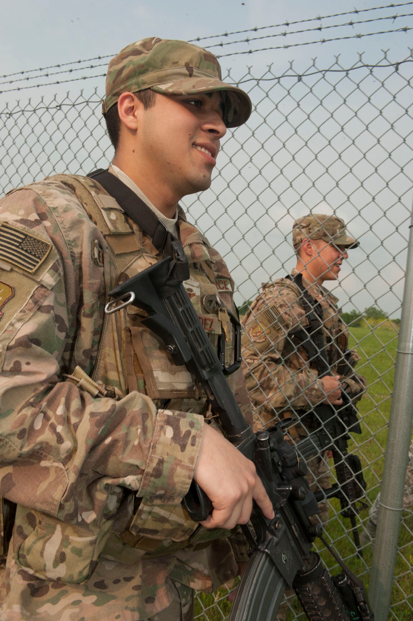 Airmen 1st Class Gibran Hernandez (left), and Brett Payne (right), 91st Missile Security Forces Squadron fire team members, patrol the fence line during shift change-over at the Bravo-01 Missile Alert Facility near Ruso, N.D., July 1, 2015. 91st MSFS working at the MAF are on 12-hour shifts and when the day and night crew swap for change-over, a full patrol of the area outside the MAF is conducted. (U.S. Air Force photo/Senior Airman Stephanie Morris)