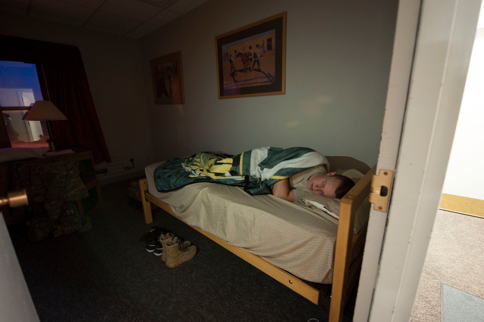 Airman 1st Class Brett Payne, 91st Missile Security Forces Squadron fire team member, lies in his bunk after completing his shift at the Bravo-01 Missile Alert Facility near Ruso, N.D., July 1, 2015. Payne and his fellow defenders work to ensure the safety and security of the missile crew members and other personnel stationed at the MAF, which functions as a central command center and hotel hybrid for the flight area. (U.S. Air Force photo/Senior Airman Stephanie Morris)